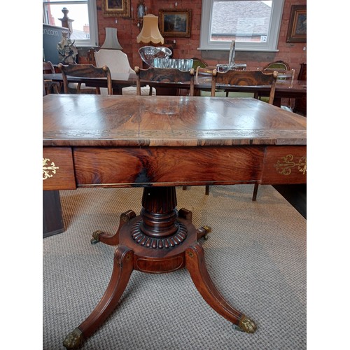 710 - A Regency rosewood and brass inlaid sofa table, in the manner of George Bullock, the drop leaf top w... 