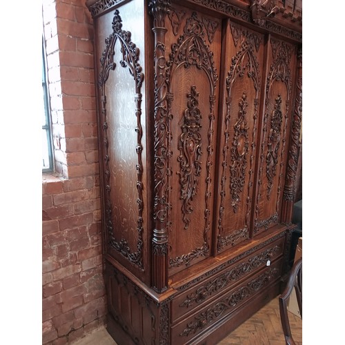 735 - A Scottish baronial oak hall cupboard, late 19th century, the castellated cornice and Gothic spire f... 