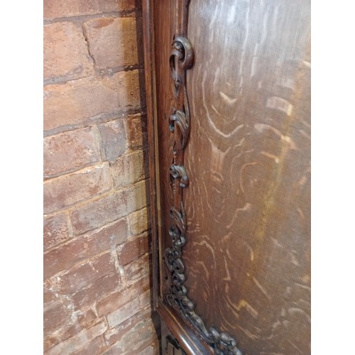 735 - A Scottish baronial oak hall cupboard, late 19th century, the castellated cornice and Gothic spire f... 