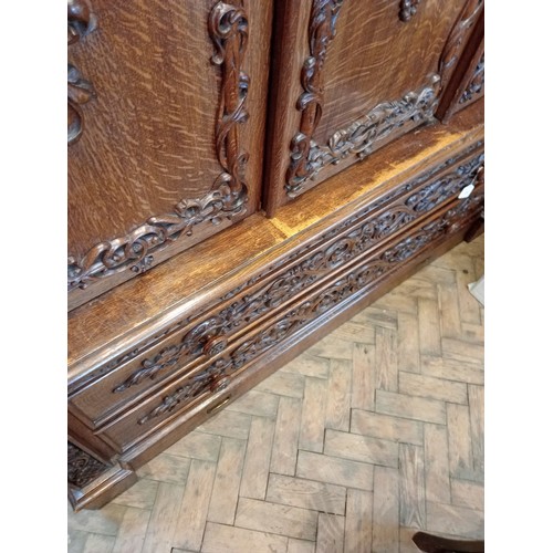 735 - A Scottish baronial oak hall cupboard, late 19th century, the castellated cornice and Gothic spire f... 