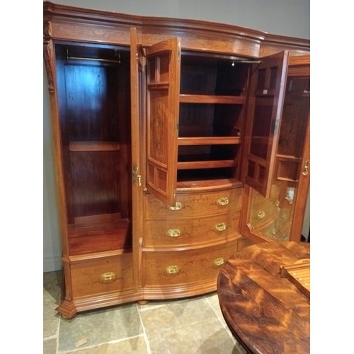 769 - An Edwardian satinwood breakfront wardrobe by Maple & Co, London, the moulded cornice over a frieze ... 