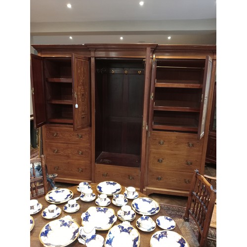 768 - An Edwardian inlaid mahogany gentleman’s compactum wardrobe, by Hampton & Sons, London, of breakfron... 