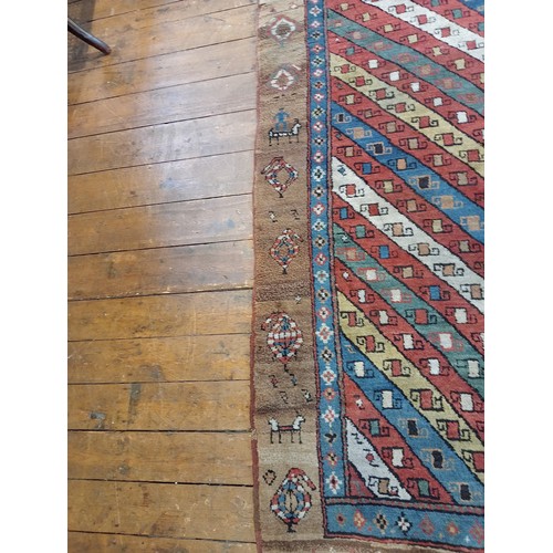 631 - A Sarab hand knotted wool rug, the central field with alternating red, green, blue and white diagona... 