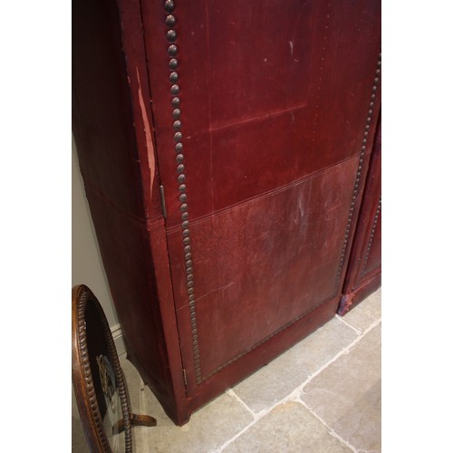 781 - An impressive and large red leather wardrobe, mid 20th century, of triple arched form, the pair of c... 