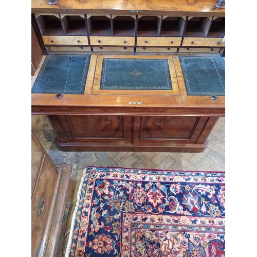 742 - A Victorian burr walnut cylinder bureau bookcase, the moulded and rounded cornice over a pair of gla... 