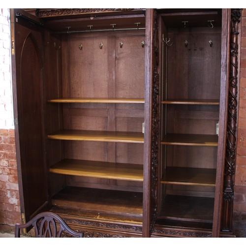 735 - A Scottish baronial oak hall cupboard, late 19th century, the castellated cornice and Gothic spire f... 