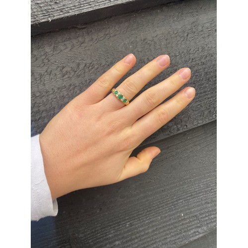 126 - A mid 20th century untested emerald and diamond ring, the central oval cut untested emerald with two... 