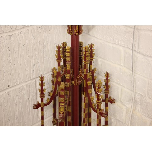 614 - A painted iron Puginesque chandelier, late 20th century, in red and yellow colourways, formed with a... 