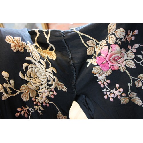 589 - An early-mid 20th century Japanese kimono, heavily embroidered in pink and gold with an abundance of... 