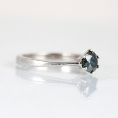 181 - A colour treated 'blue' diamond, the round cut diamond within white metal claw setting edge leading ... 