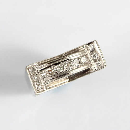 185 - An Art Deco designed diamond set cocktail ring, the raised diamond set shoulders with channel of fiv... 