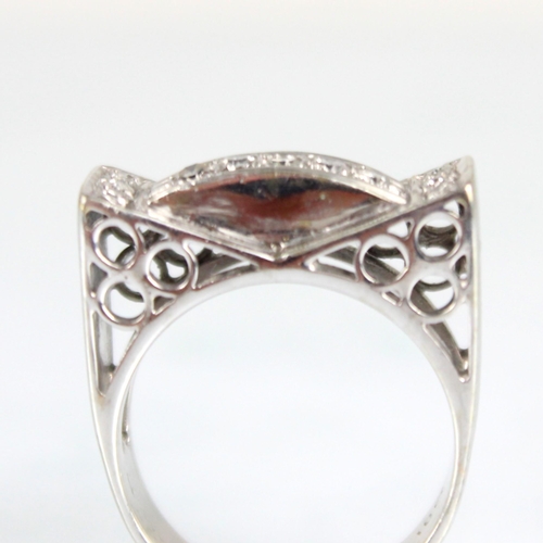 185 - An Art Deco designed diamond set cocktail ring, the raised diamond set shoulders with channel of fiv... 