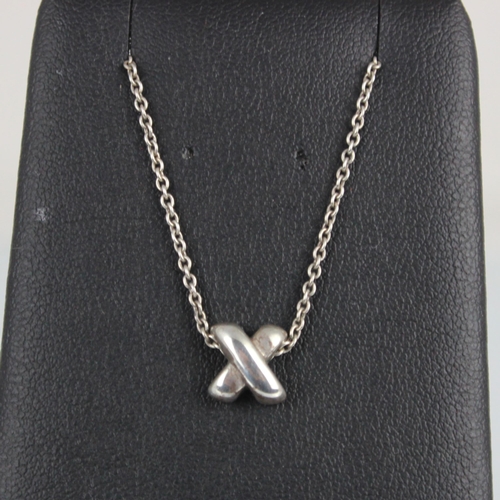 195 - A Tiffany and Co silver 'X' pendant, of stylised plain polished form, stamped 'Tiffany and Co 925' u... 