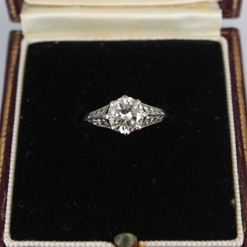 202 - An early 20th century Art Deco diamond solitaire ring, the central transitional cut diamond within w... 