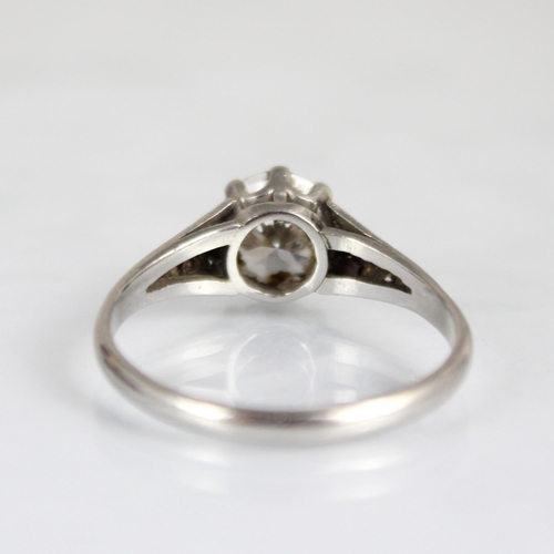 202 - An early 20th century Art Deco diamond solitaire ring, the central transitional cut diamond within w... 