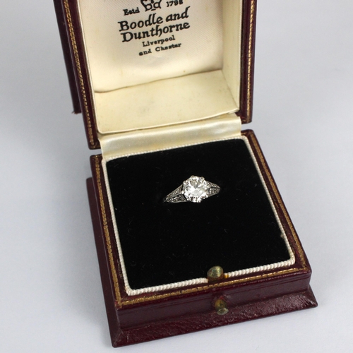 202 - An early 20th century Art Deco diamond solitaire ring, the central transitional cut diamond within w... 