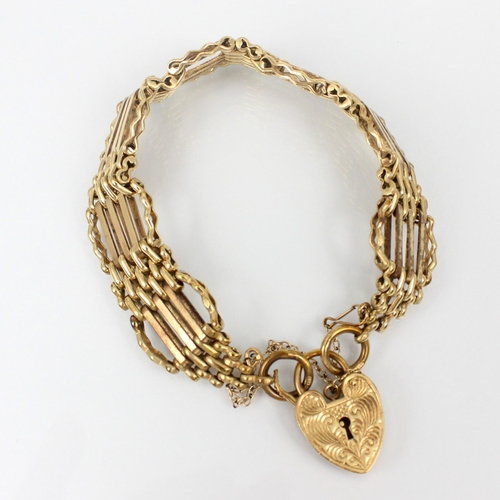 208 - A 9ct yellow gold gate link bracelet, the stylised gate link bracelet suspending a heart shaped fast... 