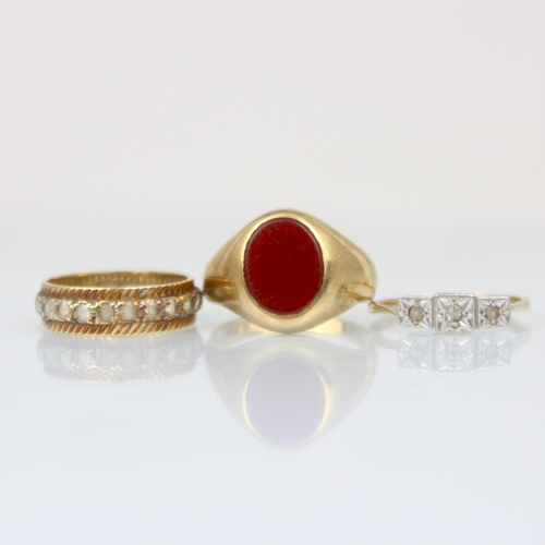 217 - A group of three rings, including a 9ct carnelian set signet ring, ring size R, with an Edwardian st... 