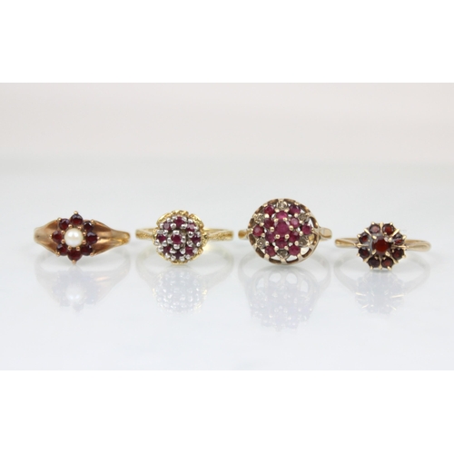 219 - A group of three untested garnet rings, including a raised cluster example, with textured shoulders ... 