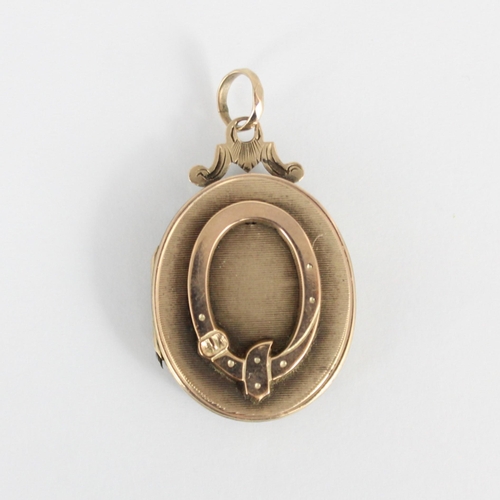 225 - A 19th century gold plated locket, the oval locket with applied buckle style detail to front and eng... 