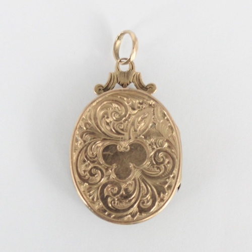 225 - A 19th century gold plated locket, the oval locket with applied buckle style detail to front and eng... 