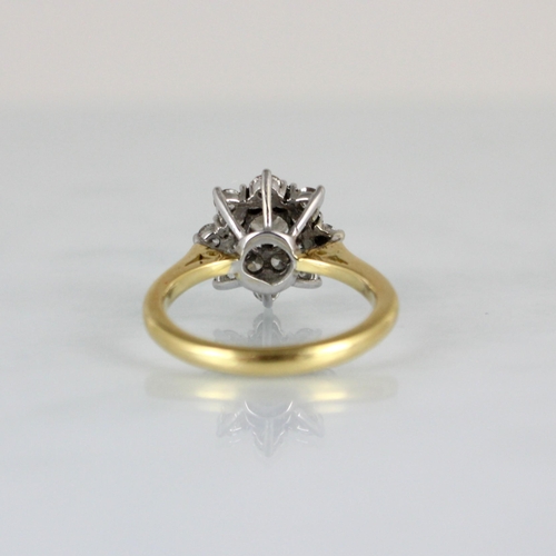 233 - A mid 20th century diamond cluster ring, the raised central round cut diamond within double surround... 