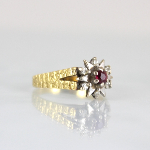 234 - An 18ct yellow gold diamond ring, the central round cut untested ruby raised above white metal and d... 