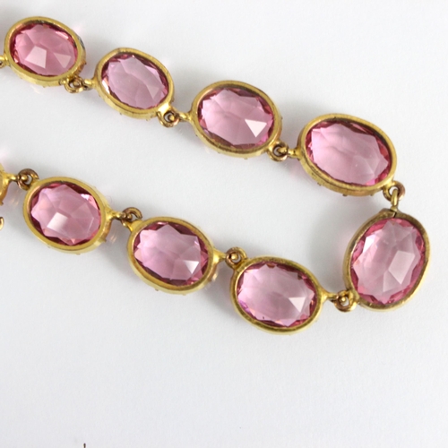 236 - An early/mid 19th century gilt metal paste necklace, the twenty graduated oval cut pink stones withi... 