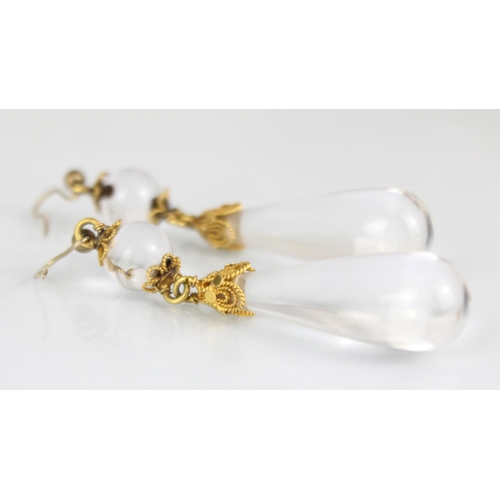 240 - A pair of rock crystal earrings, the sphere with gilt metal cannetille terminals, suspending a furth... 