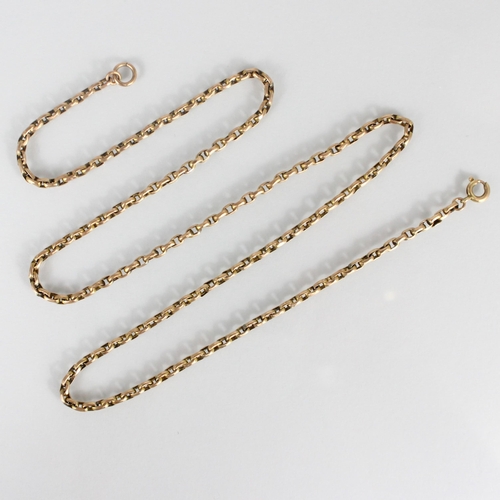 249 - An early 20th century yellow metal chain, the long guard style chain with applied ‘9c’ pad and assoc... 