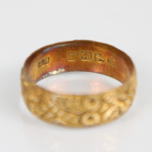 252 - A 19th century 18ct yellow gold ring, continuously engraved with floral design, indistinctly stamped... 