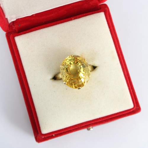 257 - A bespoke untested yellow sapphire cocktail ring, possibly Sri Lankan, the fancy oval cut stone with... 