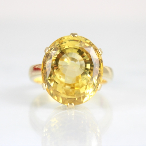 257 - A bespoke untested yellow sapphire cocktail ring, possibly Sri Lankan, the fancy oval cut stone with... 