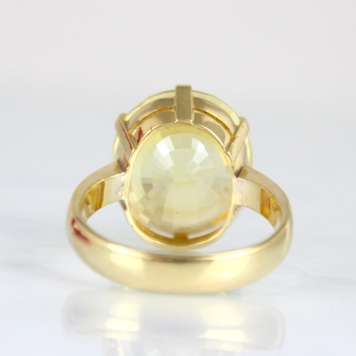 257 - A bespoke untested yellow sapphire cocktail ring, possibly Sri Lankan, the fancy oval cut stone with... 