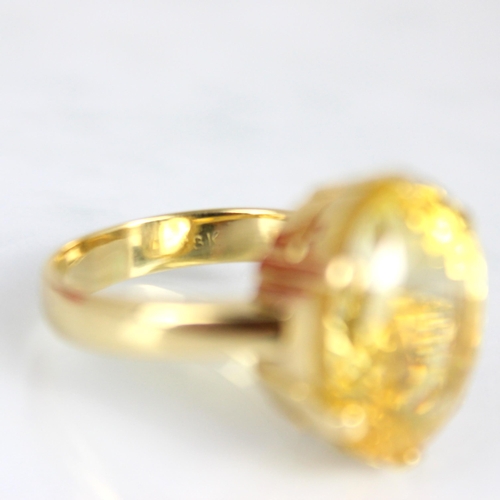 257 - A bespoke untested yellow sapphire cocktail ring, possibly Sri Lankan, the fancy oval cut stone with... 