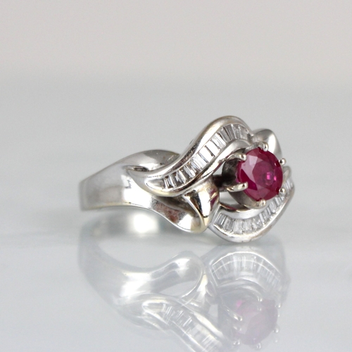 259 - A ruby and diamond stylised cluster ring, the central raised round cut ruby within baguette cut diam... 