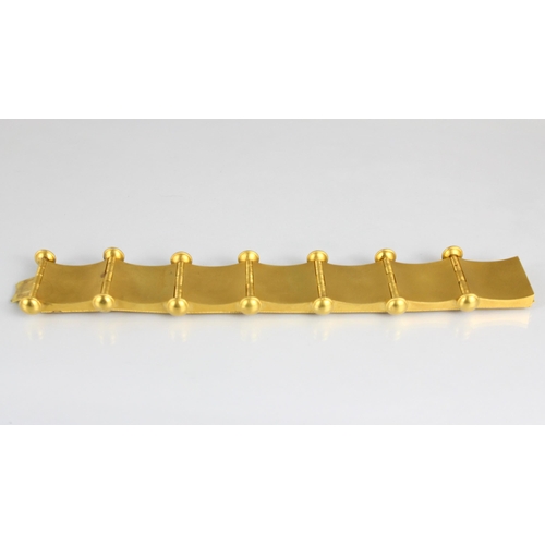 265 - A 19th century Etruscan Revival yellow metal bracelet, the seven square shaped panels with central s... 