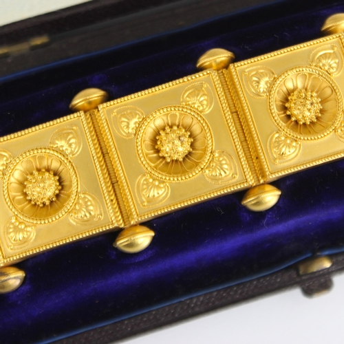 265 - A 19th century Etruscan Revival yellow metal bracelet, the seven square shaped panels with central s... 