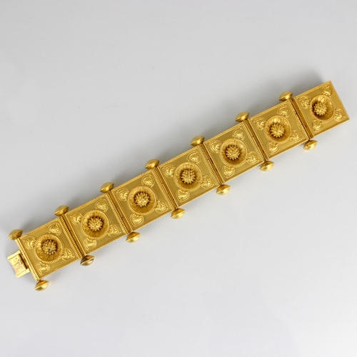 265 - A 19th century Etruscan Revival yellow metal bracelet, the seven square shaped panels with central s... 