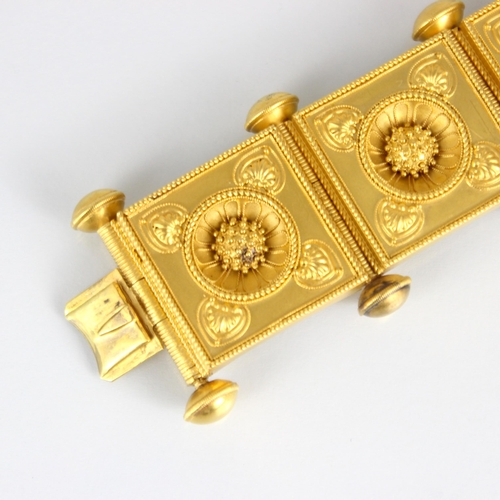 265 - A 19th century Etruscan Revival yellow metal bracelet, the seven square shaped panels with central s... 