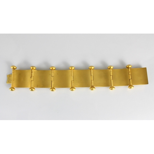 265 - A 19th century Etruscan Revival yellow metal bracelet, the seven square shaped panels with central s... 