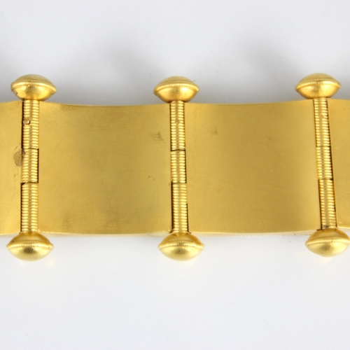 265 - A 19th century Etruscan Revival yellow metal bracelet, the seven square shaped panels with central s... 