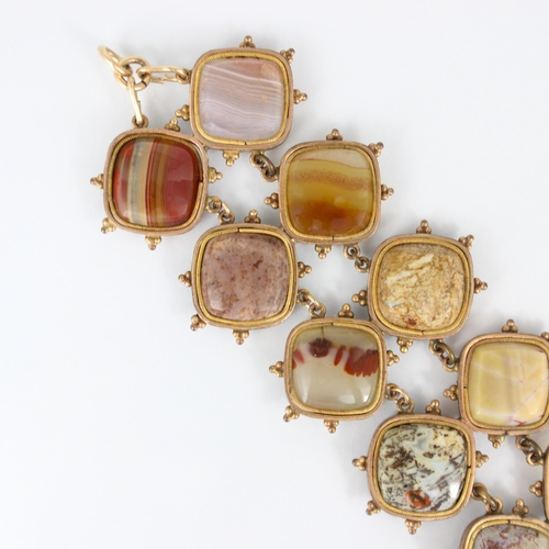 267 - A 19th century banded agate bracelet, the fourteen shaped panels within a gold plated rub over style... 