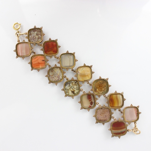 267 - A 19th century banded agate bracelet, the fourteen shaped panels within a gold plated rub over style... 