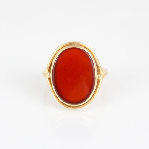 270 - A 19th century style carnelian set ring, the oval cut carnelian within rub over and openwork mount, ... 