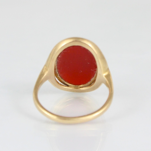 270 - A 19th century style carnelian set ring, the oval cut carnelian within rub over and openwork mount, ... 