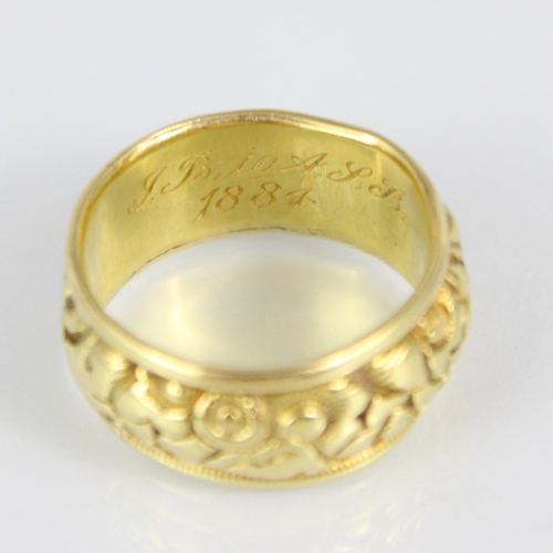 273 - A 19th century yellow metal ring, with continuous floral design, engraved to interior ‘JB to AJB 188... 