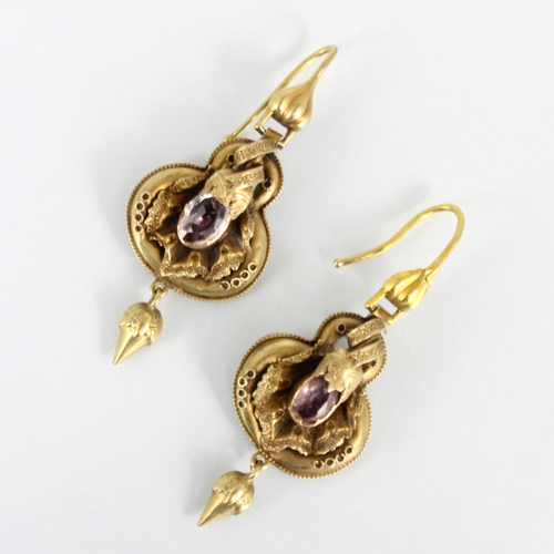 279 - A pair of 19th century gold coloured drop earrings, the shaped earring with foil backed pink stone d... 