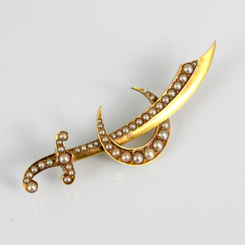 281 - A 19th century yellow metal pearl set brooch, designed as a sword within crescent moon, set with gra... 