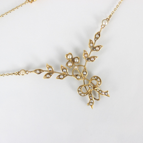 294 - An early 20th century yellow metal and seed pearl necklace, the foliate designed front with trefoil ... 